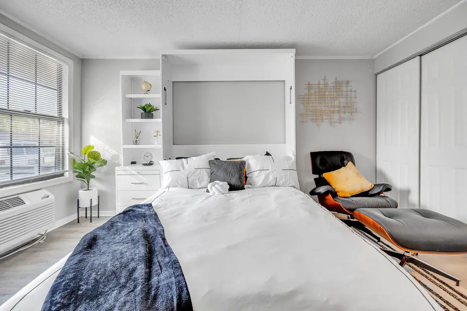 A furnished apartment bedroom at Jax Bay in Jacksonville, Florida.