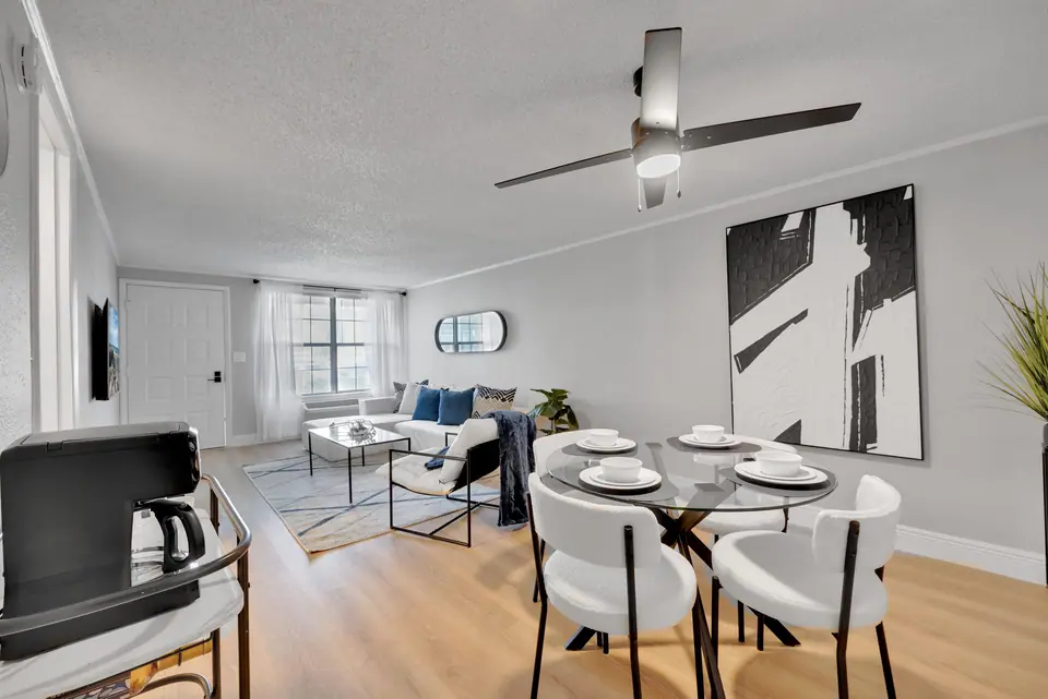 An open-concept dining and living room at Jax Bay in Jacksonville, Florida.