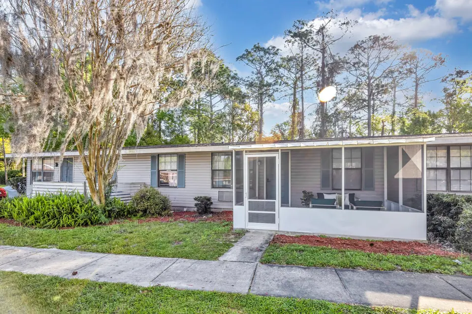 A screened porch and apartment exterior at Jax Bay in Jacksonville, Florida.
