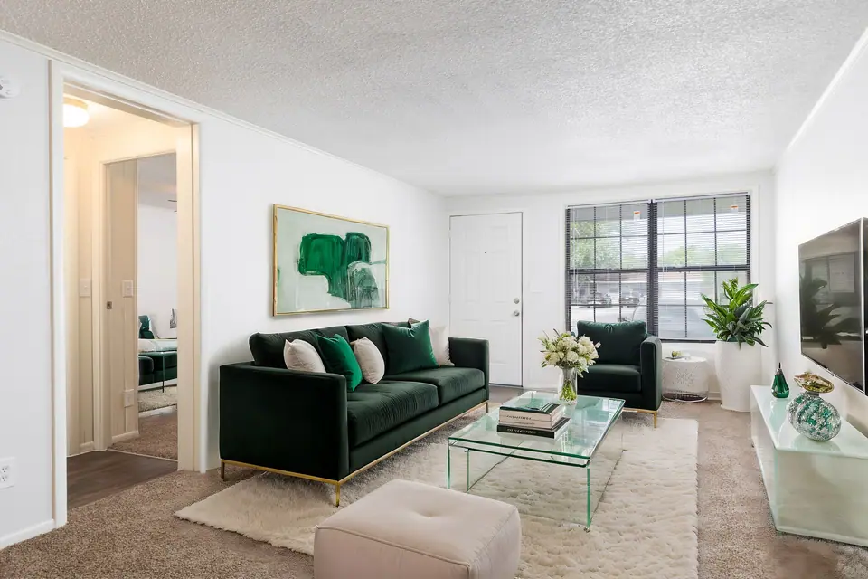 A green-accented furnished apartment living room at Palm Harbor Villas in Melbourne, Florida.