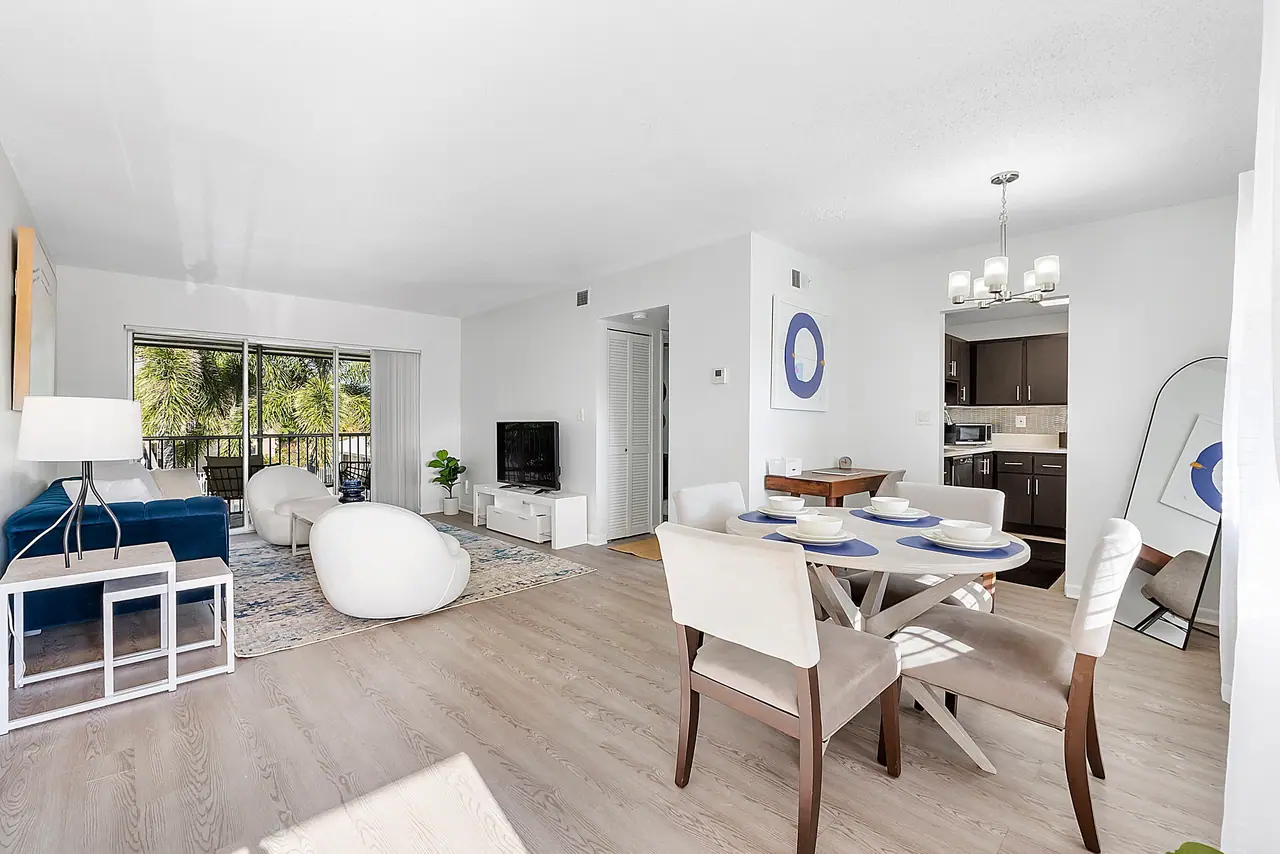 A furnished open living and dining area at Waterford Bay in Boca Raton, Florida.